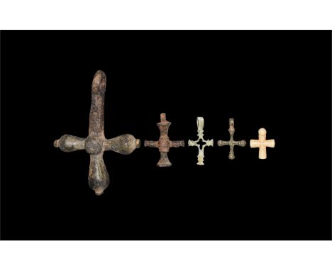 14th-16th century AD. A mixed group of cross pendants comprising: one large with bulb to each arm, central disc; one with rib