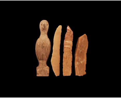 1st millennium BC. A mixed group comprising: a small ceramic bird idol standing on an integrated base with wings closed, roun