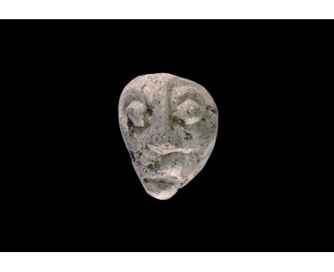 Pliocene Period, 5.2-2.5 million years BP. A mastodon fossil bone, later carving depicting a human face with prominent nose a