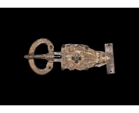 3rd-5th century AD. A silver-gilt belt buckle comprising: broad flat-section loop with beast-head finials, scroll detailing, 