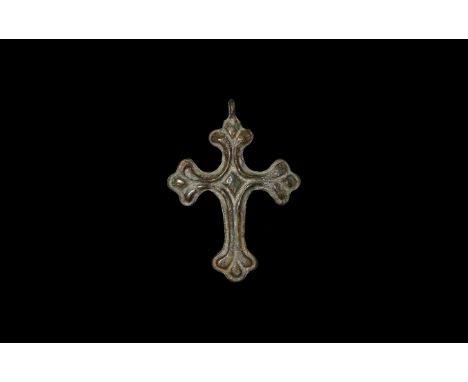 11th-12th century AD. A bronze cross botonny pendant with ribbed face and central lozenge, integral loop.   38 grams, 81mm (2