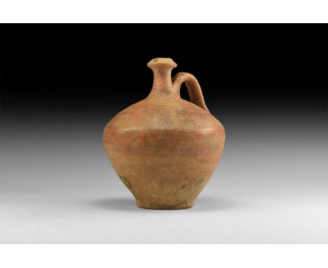 1st century AD. A terracotta flask with bulbous-shaped body, long neck with wide rim and looped handle.   363 grams, 13.5cm (
