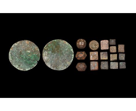 5th-7th century AD. A mixed bronze group comprising: two bronze scale pans; three polyhedral weights with ring-and-dot motifs