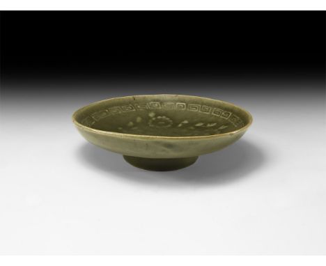 Yuan Dynasty, 1271-1368 AD. A shallow green-glazed ceramic dish with flared foot, geometric band within the rim.   371 grams,