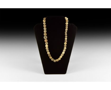 Devensian Period, 110,000-12,000 years BP. A restrung group of carved fossilised mammoth bone oblate beads.   120 grams, 58cm
