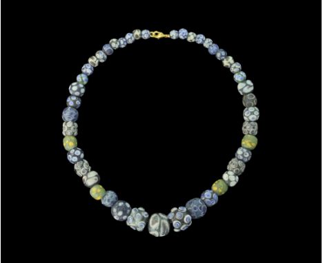 1st century BC-2nd century AD and later. A restrung necklace composed from forty-five spherical glass beads in blue and green
