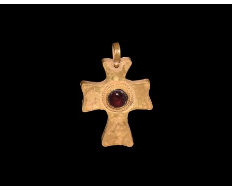 19th century AD. A hollow-formed gold cross pendant in Byzantine style with loop and granule, central garnet cabochon with ba