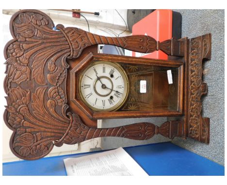 AMERICAN WALNUT CARVED MANTEL CLOCK WITH FLORAL DETAIL WITH ENAMELLED ARABIC CHAPTER RING AND GLAZED DOOR 