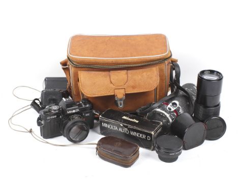 A Minolta X700 camera outfit. In a brown bag, including a Auto Winder, 200mm lens and more