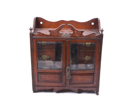 A Victorian oak smoker's pipe cabinet. Including china tobacco jar and five assorted pipes. L42cm x D19cm x H45cm