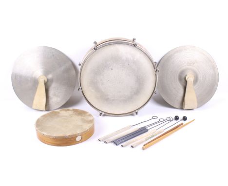 A group of percussion muscial instruments. Including a snare drum, pair of cymbals and a tambourine, etc.