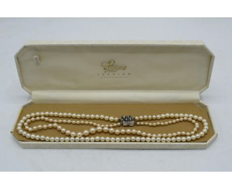 A pair of single row cultured pearl necklaces, one with silver clasp (2).  