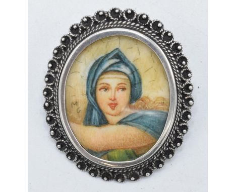 An antique miniature portrait of a robed lady signed 'M G' in .800 silver brooch mount, 35mm tall.