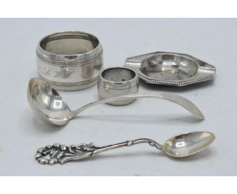 A collection of continental silver items to include small ashtray, napkin rings, a spoon and one similar (5), 72.6 grams.