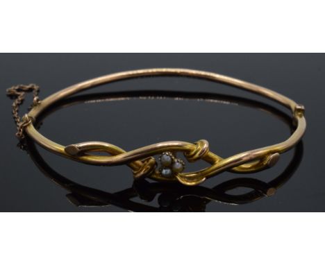 9ct gold bangle with twist decoration set with seed pearls, 5.3 grams, 7cm diameter.  