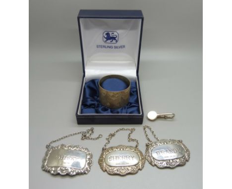 Three silver wine labels, a silver clip and a silver napkin ring, 71g 