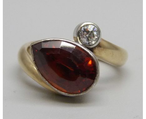 A 9ct gold, diamond and pear shape spessarite garnet ring, 5.9g, M 