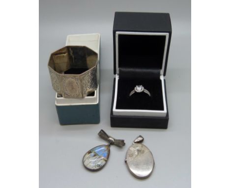 A silver American Swiss ring, N, a 925 locket, a sterling pendant and a boxed silver napkin ring 