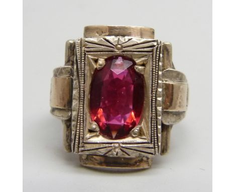 An Eastern European Art Deco silver ring with applied gold and set with a red stone, J 