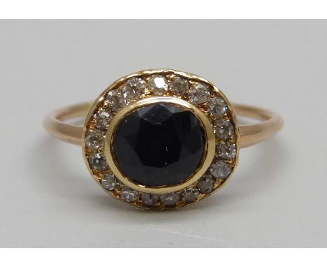 A Georgian sapphire and diamond cluster ring, tests as gold, 2.1g, M, ring back bears inscription 