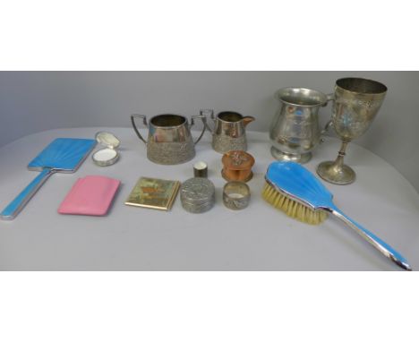 A collection of items including an Arts and Crafts style copper pot, a sugar and cream jug, a napkin ring, a pill box, a plat