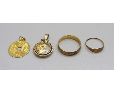 A 9ct gold ring, a small yellow metal ring, a yellow metal oriental pendant marked 999.9 and one other pendant/charm, total w