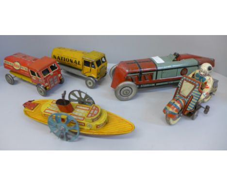 A collection of tin-plate model vehicles including a motorbike, a boat etc. 