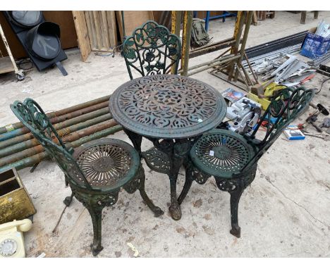 A VINTAGE HEAVY CAST IRON BISTRO SET WITH THREE CHAIRS AND A TABLE 