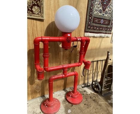 A LARGE INDUSTRIAL STYLE LIGHT IN THE SHAPE OF A BODY (H:183CM W:104CM) 