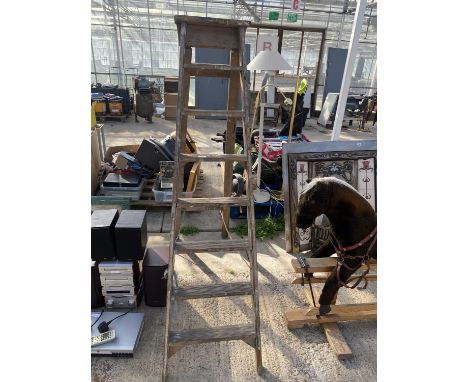 A VINTAGE SEVEN RUNG WOODEN STEP LADDER 