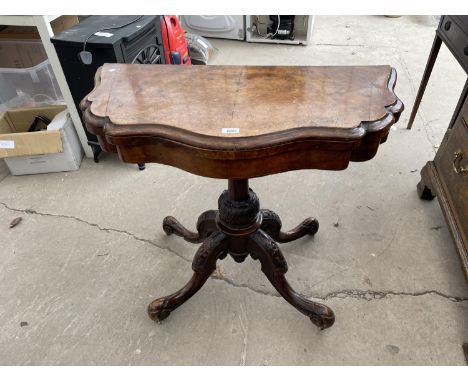 A VICTORIAN WALNUT FOLD OVER CARD TABLE ON QUATREFOIL BASE W: 35 INCHES (LACKING BAIZE) 