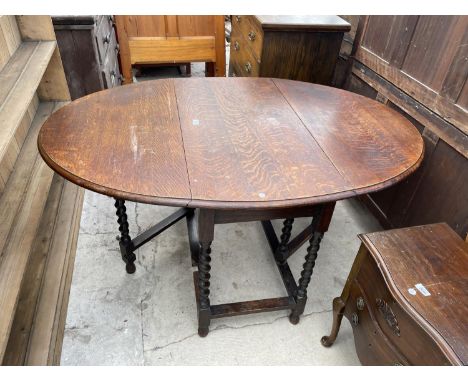 AN EARLY 20TH CENTURY OAK BARLEY-TWIST GATE-LEG DINING TABLE 