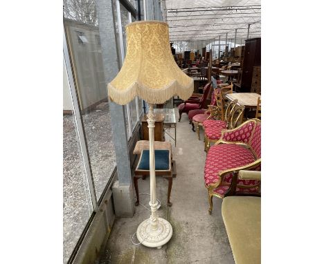 A CREAM AND GILT STANDARD LAMP COMPLETE WITH SHADE 