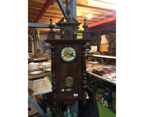 A VIENNA SPRUNG WALL CLOCK WITH PENDULUM AND KEY 