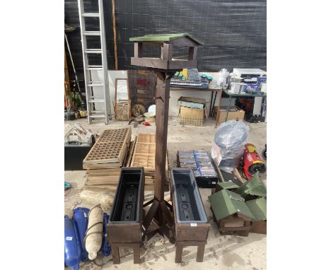 TWO WOODEN PLANTER TROUGHS AND A WOODEN BIRD TABLE 