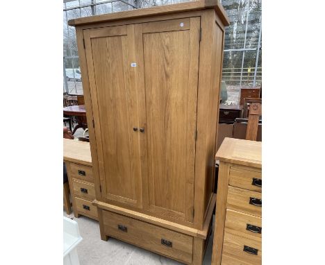 A LIGHT OAK TWO DOOR WARDROBE WITH SINGLE DRAWER TO THE BASE, 42" WIDE 