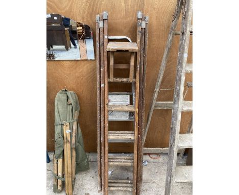 A THREE SECTION WOODEN LADDER AND A FURTHER THREE RUNG ALUMINIUM STEP LADDER 