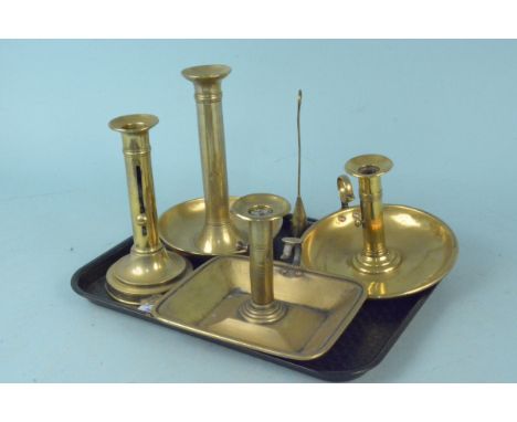 Three late 19th Century brass ejector chamber sticks together with a single ejector stick and a candle snuffer