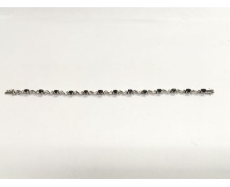 A 9ct white gold, diamond and sapphire bracelet, approx 8.59g.