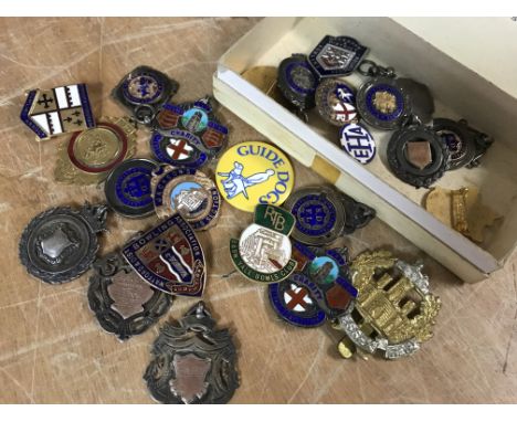 A collection of silver pendants and enamel pin badges various