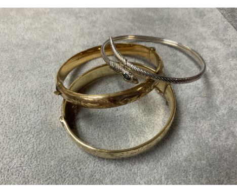 2 9ct gold core bangles together with a sterling silver snake design bangle.
