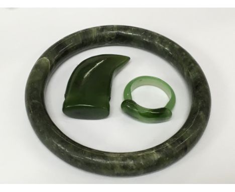 A green hard stone bangle, ring and pendant