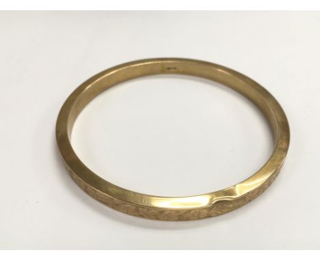 A cased 9ct gold bangle, approx 18g.