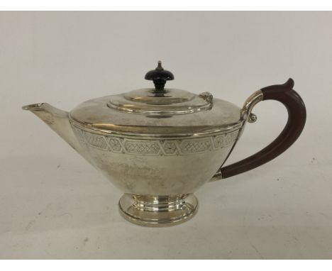 A hallmarked silver teapot with engraved decoration, Birmingham 1960. Approx 600g.