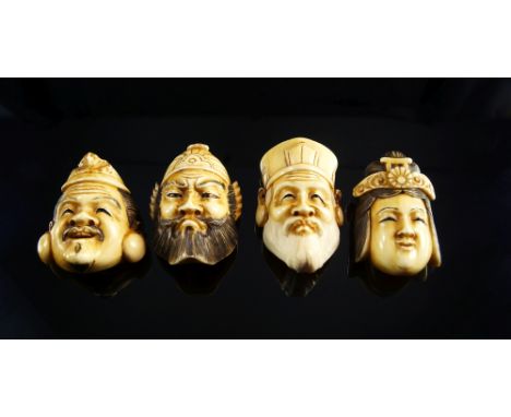 Four Japanese ivory netsuke, early 20th century, in the form of faces, 4.5cm high CONDITION REPORT: in good condition, no con