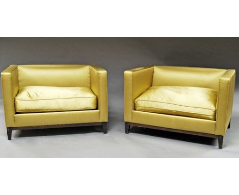 A pair of gold satin upholstered oversized arm chairs, 20th century, raised on tapering square legs, 72cm high x 107cm wide x
