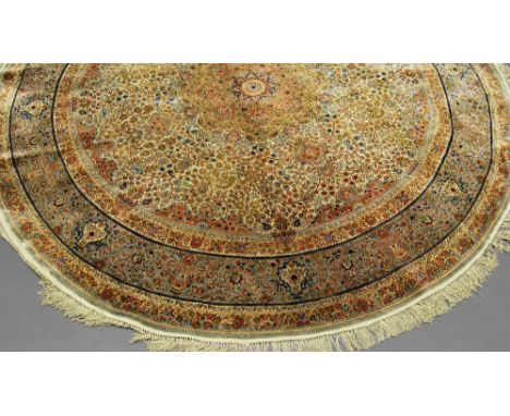 An Isfahan circular silk rug with foliate stems in an ivory field, 186 cm diameter and a silk Tabriz prayer rug with animals 