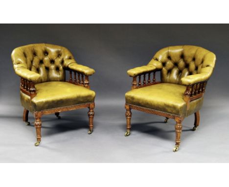 A pair of Victorian oak framed button back arm chairs, with hide upholstery and open gallery arm supports, (2). CONDITION REP