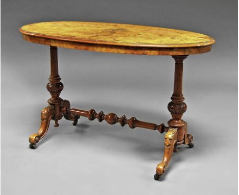 A Victorian walnut oval table, raised on turned and carved legs, ceramic casters, 69cm high x 113cm wide x 61cm deep.  
 COND
