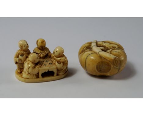 A Japanese ivory manju netske, 19th century, modelled as an apple or gourd, with a branch, 3.5cm diameter, together with anot